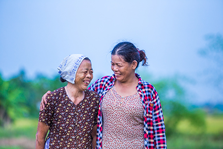 Photo by Lisa Murray for CRS Xuan and her mother now have peace of mind with an early warning system and evacuation plan that will help protect them during destructive storms.