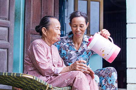 Photo by Lisa Murray for CRS Le Thi Phuoc and her elderly mother can now sleep well at night, knowing their home’s new roof can stand up to the fierce storms that lash their small village in central Vietnam.