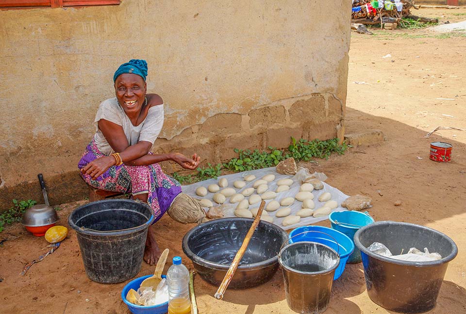 woman displays shea butter batch in Benin