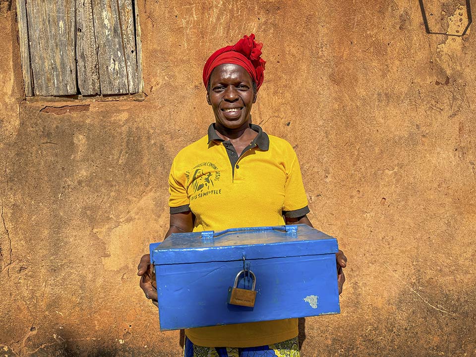 woman holding savings group money box in Central African Republic
