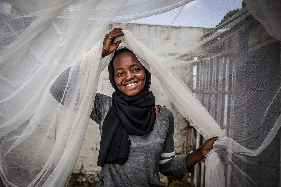 woman in Gambia with mosquito net