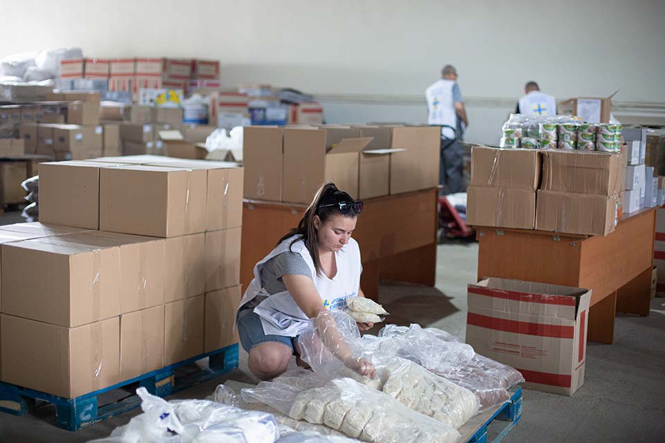 woman packs supplies in Ukraine.