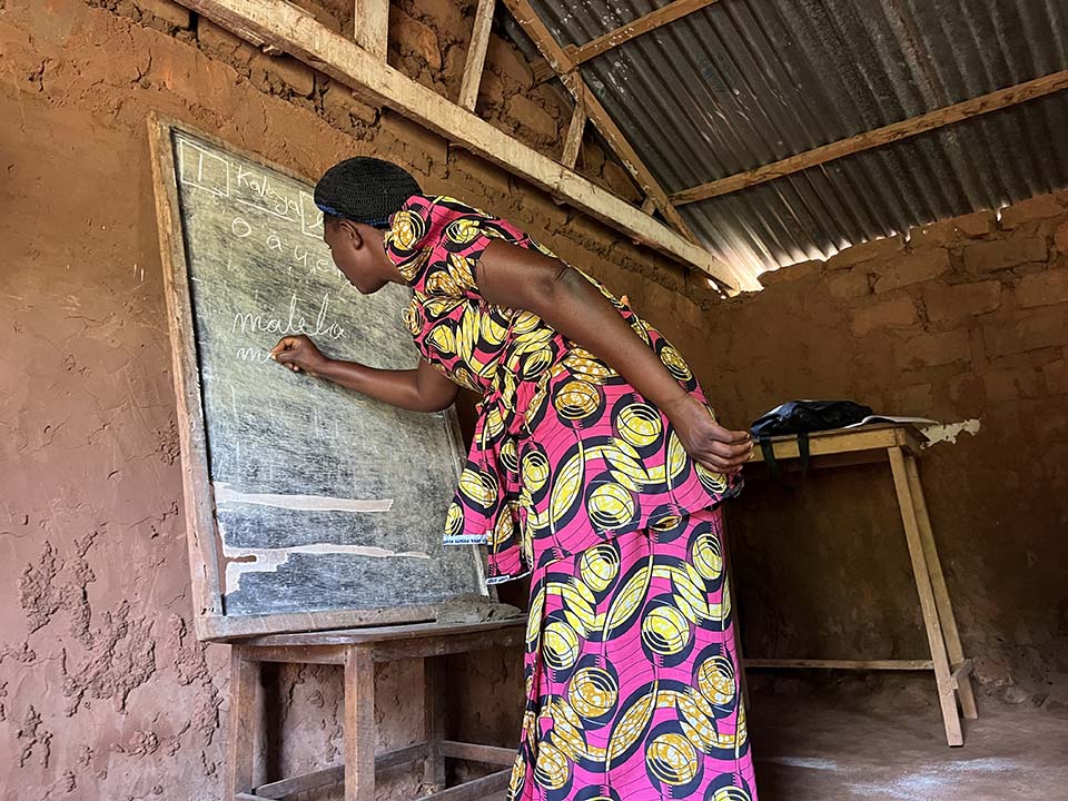 woman practices spelling out words at the Morning Star Literacy Center in DRC