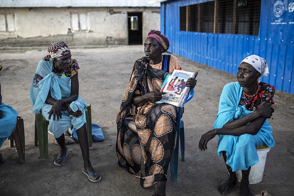 woman talkes to circle of women about nutrition in South Sudan