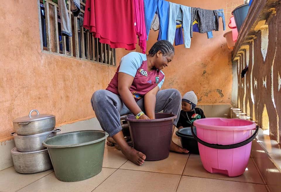 woman washes clothes in Cameroon 