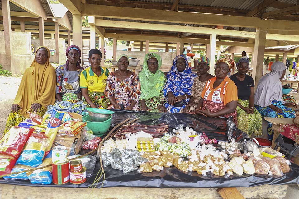 women gather at Benin village market