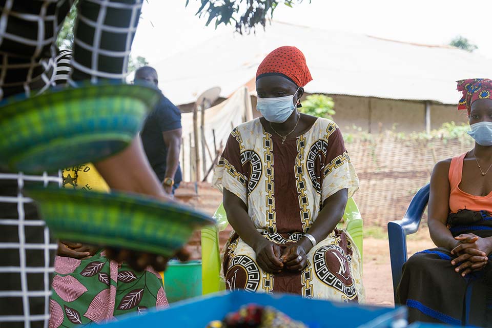 Women in a CRS-supported SILC program in Guinea-Bissau collect funds