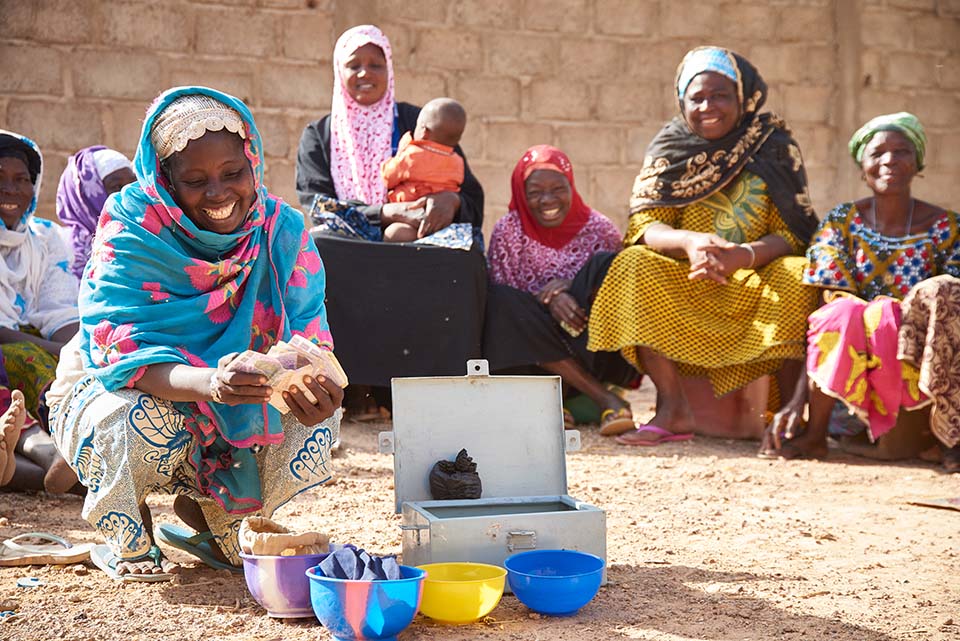 women participate in microfinance savings group in Burkina Faso