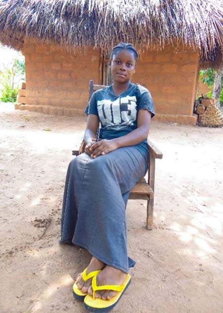 young woman seated outside in DRC