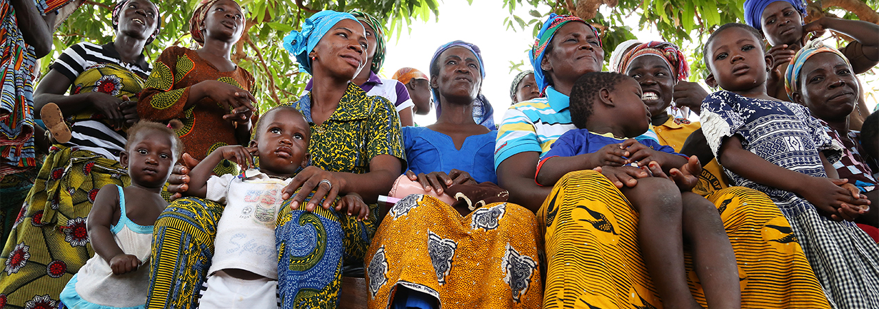 People in northern Ghana attend a community meeting that is mobilizing and educating people related to health issues, including increasing access to quality health care, improving nutrition and reducing malaria. Photo by Michael Stulman/CRS