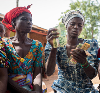 Two women with money in their hands.
