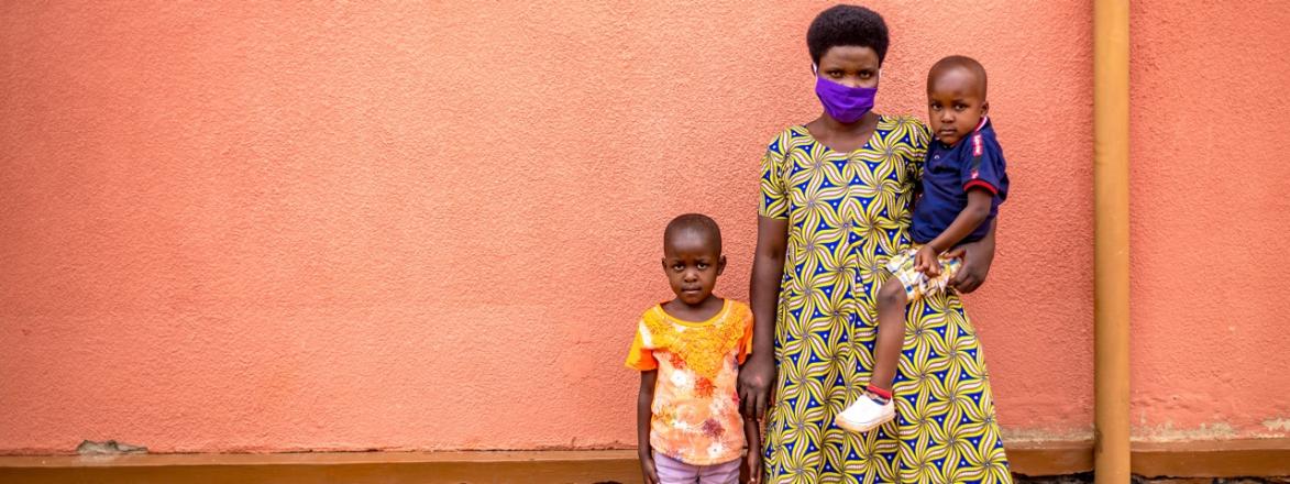 masked woman with two children