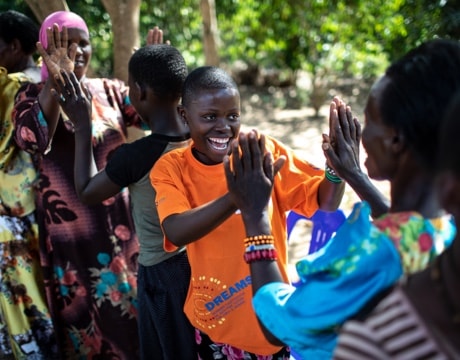 Resty Nambajo (orange shirt), 16, who is in Grade S3, interacts with her mother while taking part in a Sinovuyo training in Kaleere village, Ddwaniro subcounty, Rakai district, Uganda.