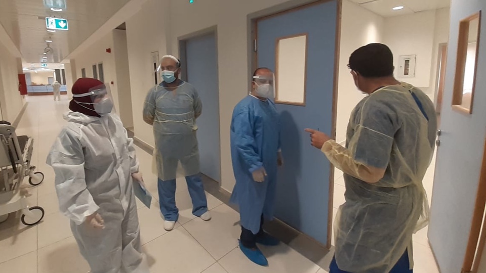 Hospital workers in protective gear.