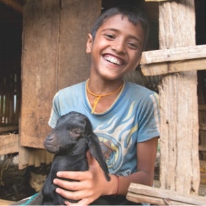 Child holding goat