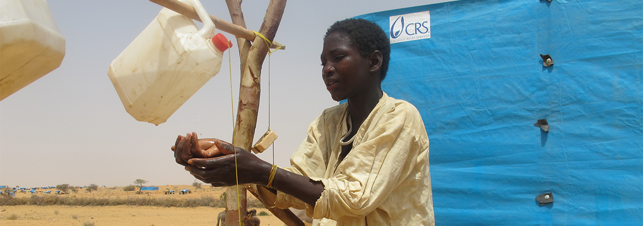 An easy-to-make hand washing system known as a "tippy tap" is demonstrated in Niger. Photo by Souradja Mahaman/CRS