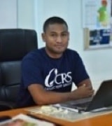 Toky Andrianarivo at a desk using a laptop