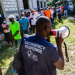 CRS representative holding a speakerphone