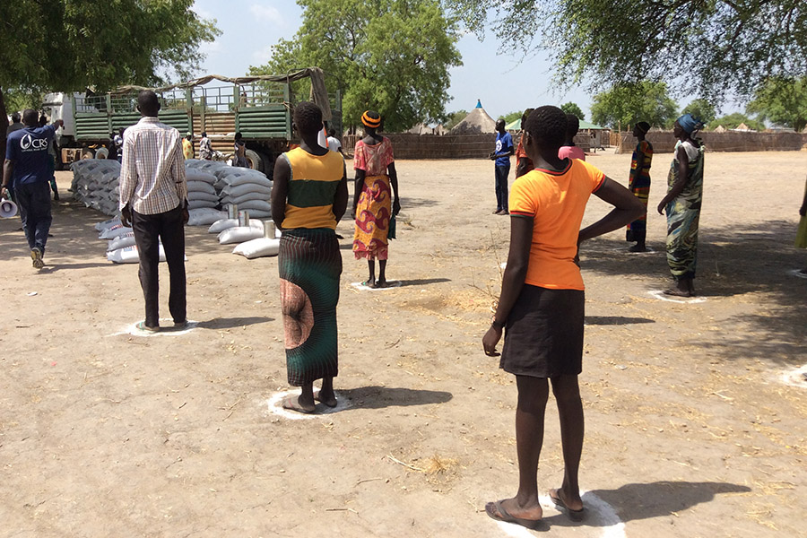 People in South Sudan practice social distancing while waiting to receive food rations