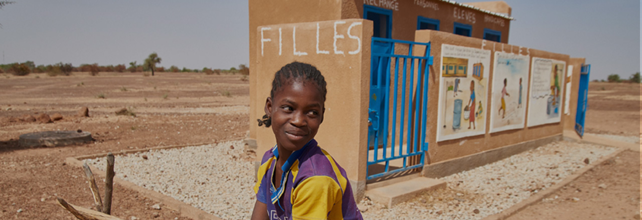 Young girl in front of a building.