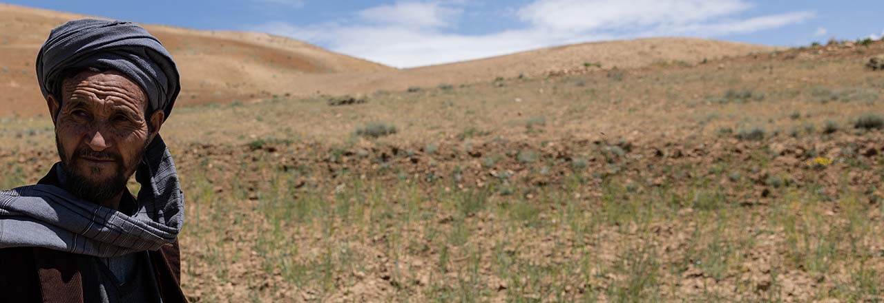 Afghan man with hills in background 