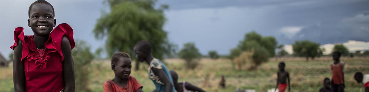 girl pumping water at a well in South Sudan