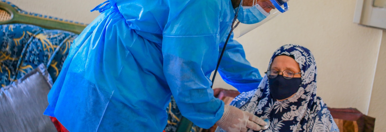 Hospital worker helping patient