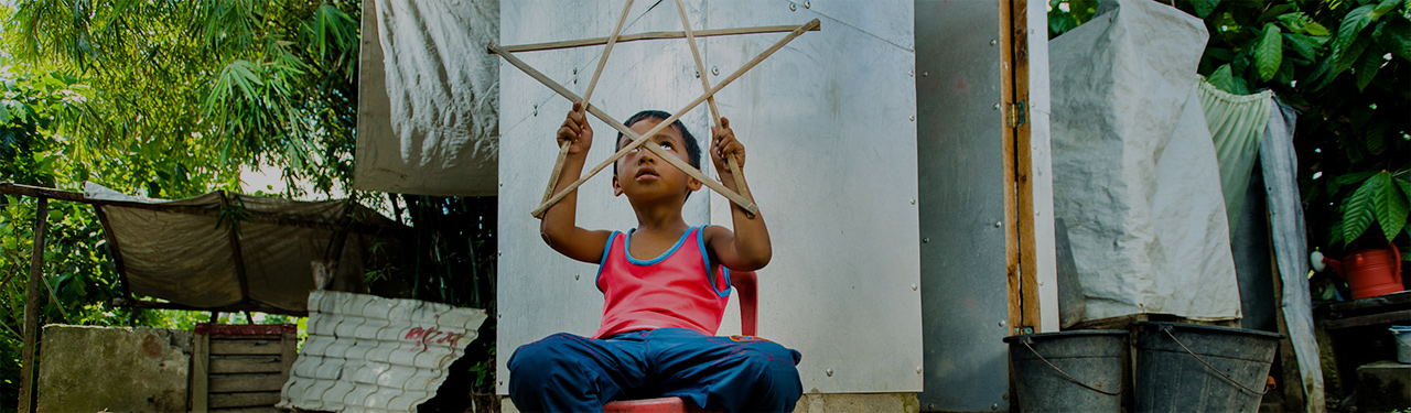 Photo by Charlie David Martinez for CRS Ryle Andre Dalde plays with his Christmas star lantern.