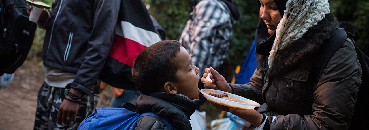 Photo by Andrew McConnell for CRS Refugees from Syria and Afghanistan cross the border from Serbia.