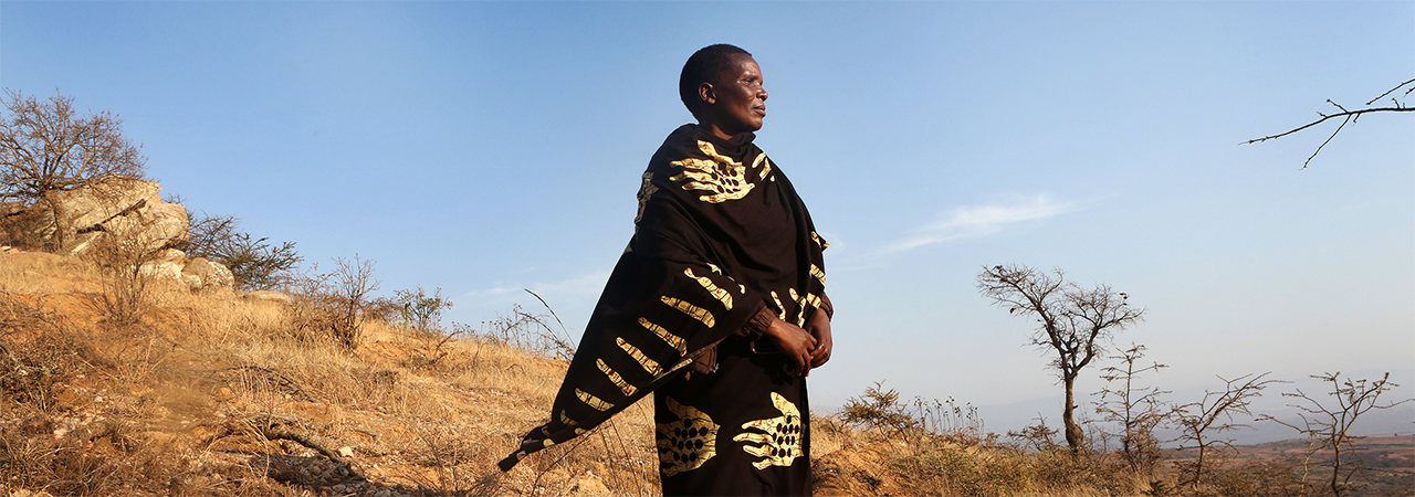 Yasinta Amsi, Saramay Hill catchment committee secretary stands in a ridge that her community constructed to prevent soil erosion in Karatu, Tanzania.