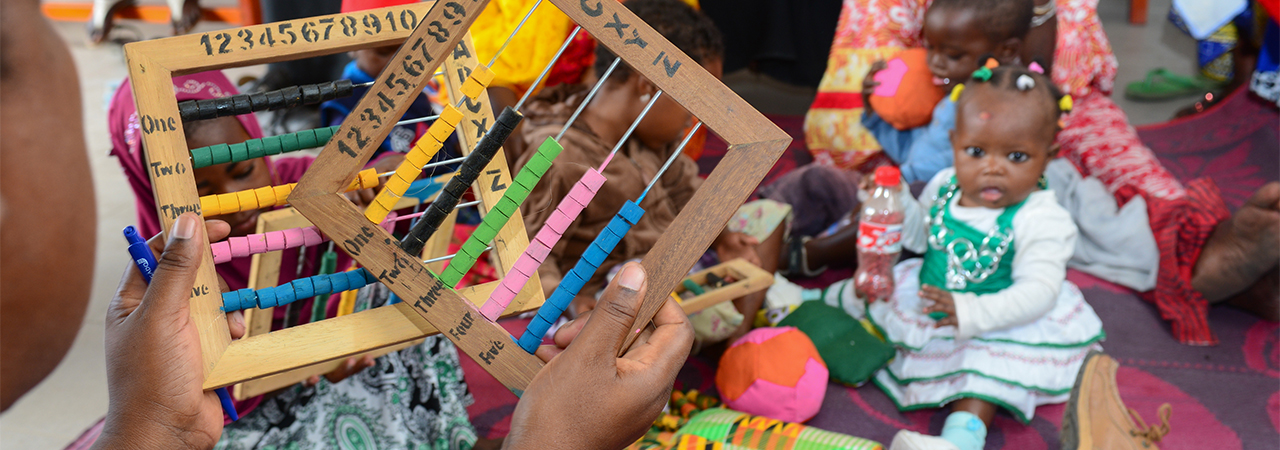 Parents learn to make toys for their children as part of CRS' THRIVE program. Photo by Philip Laubner