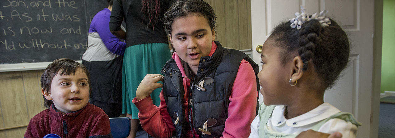 Emily Mora, teaches her students how to pray.