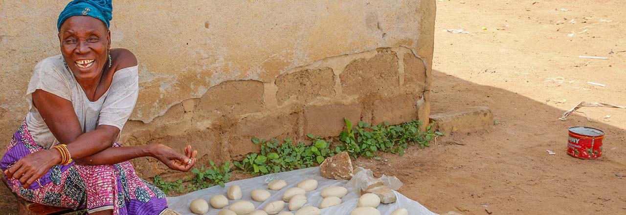 woman displays shea butter batch in Benin
