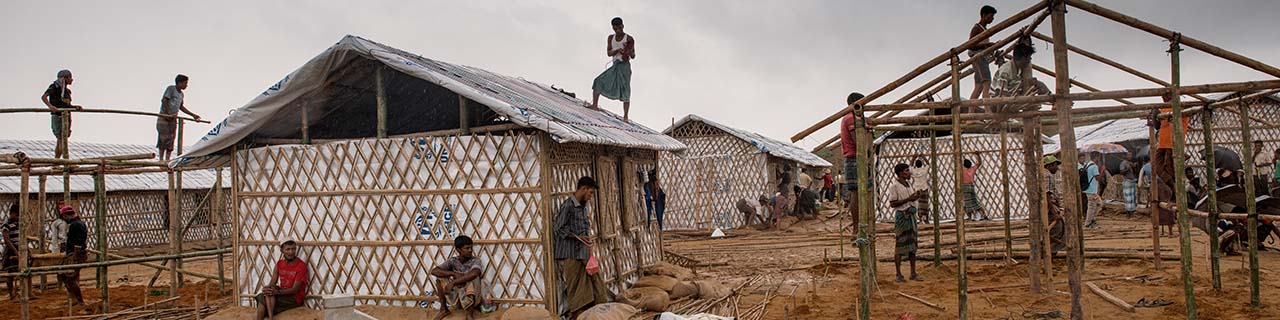 workers build shelters in a Bangladesh camp for Rohingya refugees