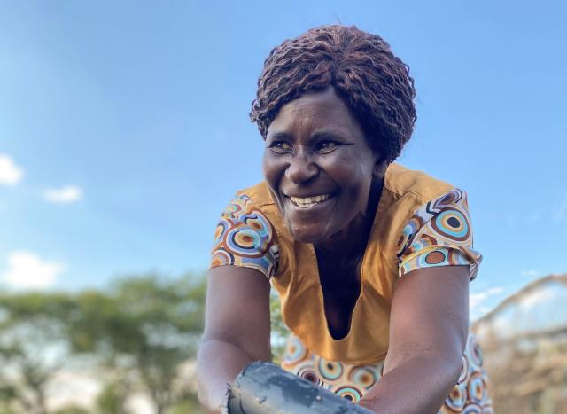 A woman washes her hands outside in Zimbabwe.