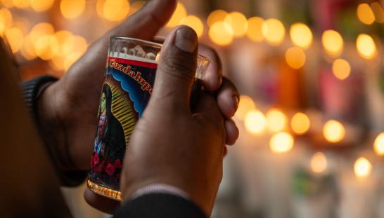 hands holding votive candle