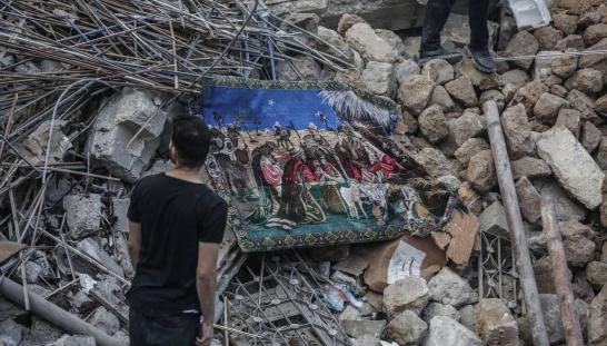 A man standing in front of rubble.
