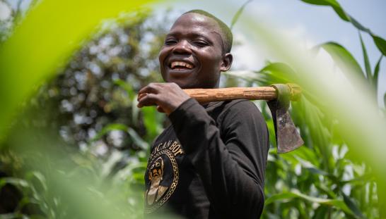 A man holding a farming tool.
