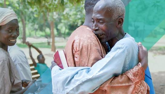 2 men hugging.
