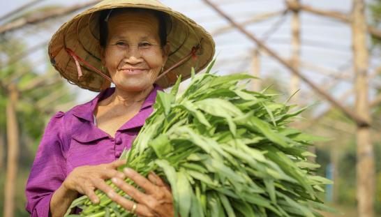 Woman holding a bundle of greens