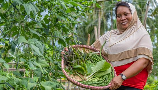 Woman holding basket of greens