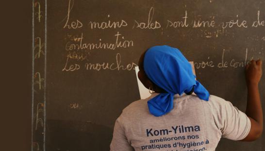 A woman looking at a school board.