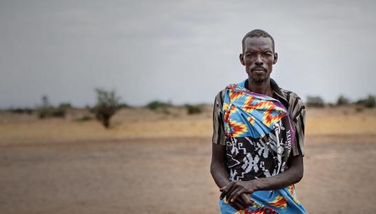 portrait of man in front of dry land