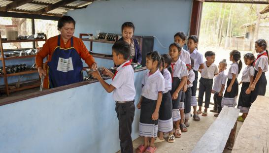children lined up for school lunch