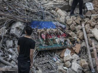A man standing in front of rubble.
