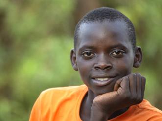 A young boy in orange t-shirt.