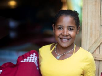 A woman holding her sewing project