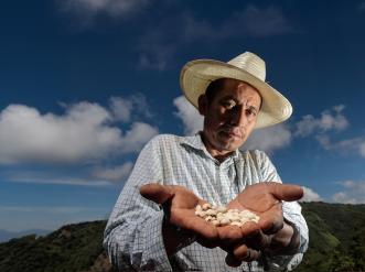 farmer holding produce harvested from his farm
