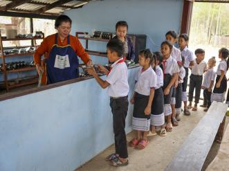 children lined up for school lunch