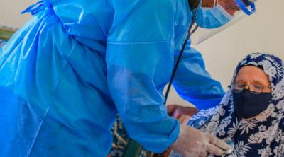 Hospital worker helping patient
